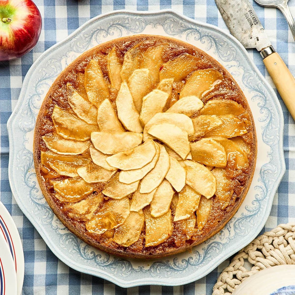 Apple upside-down cake topped with overlapping apple slices.
